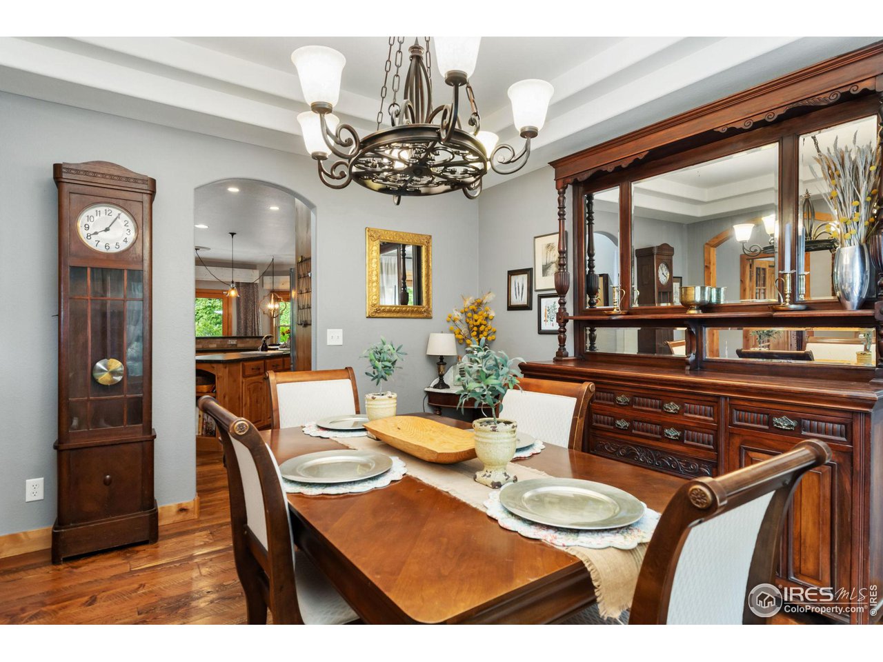 8265 Spinnaker Bay Drive Windsor, CO 80528 - Photo 14 of 40 a view of a dining room with furniture and chandelier
