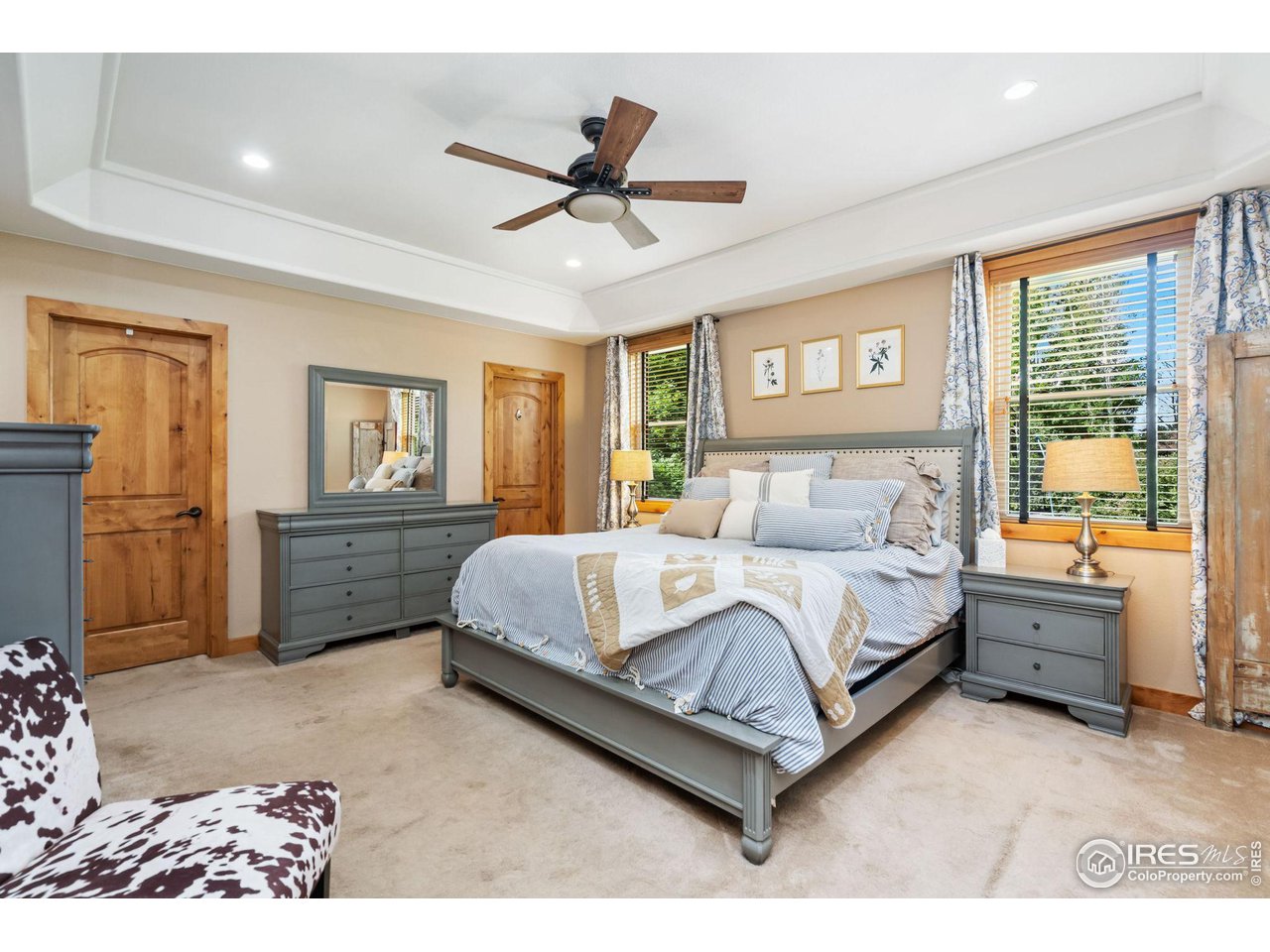 8265 Spinnaker Bay Drive Windsor, CO 80528 - Photo 15 of 40 a spacious bedroom with a bed a window and dresser