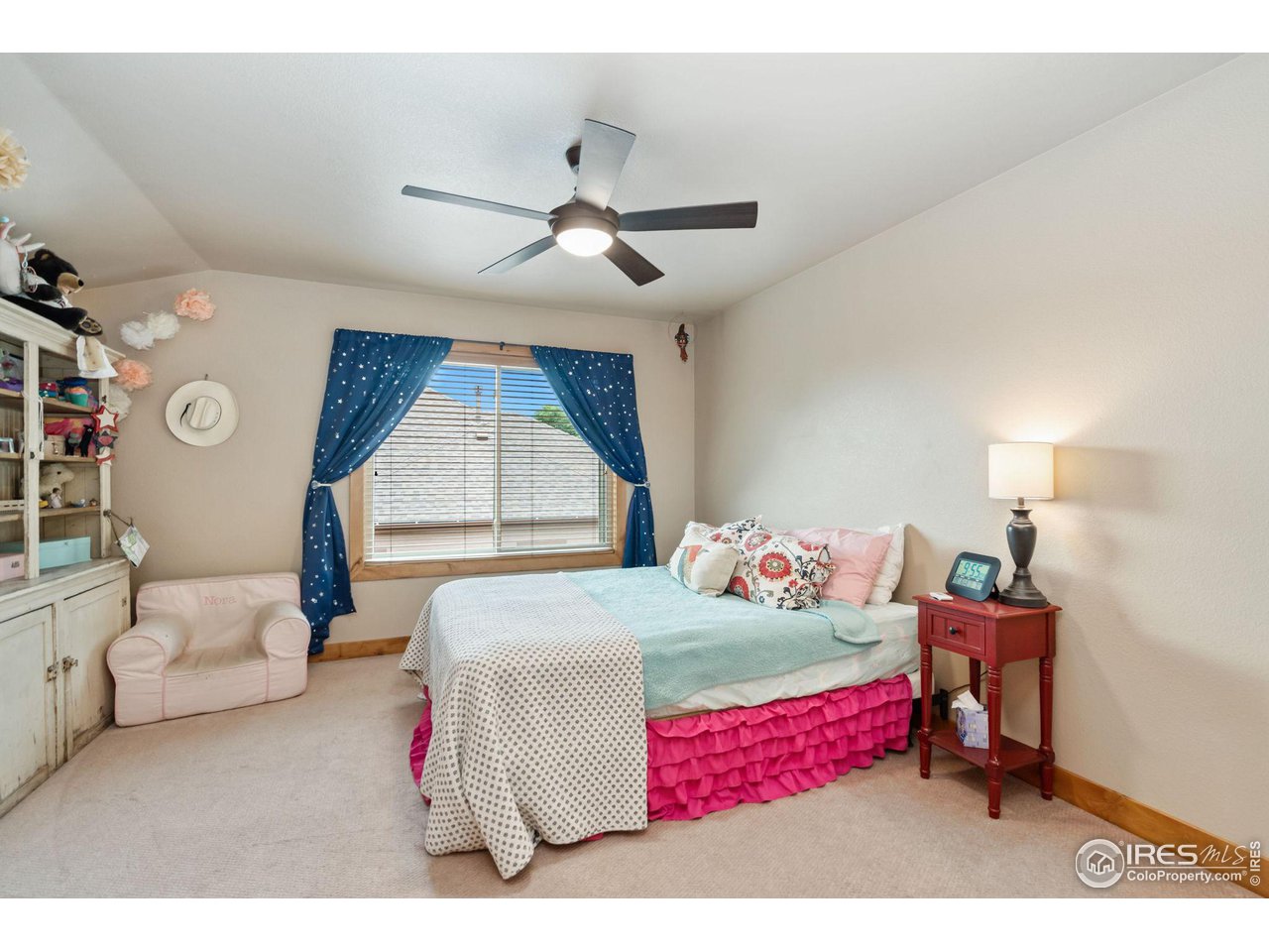 8265 Spinnaker Bay Drive Windsor, CO 80528 - Photo 18 of 40 a bedroom with a bed and a window