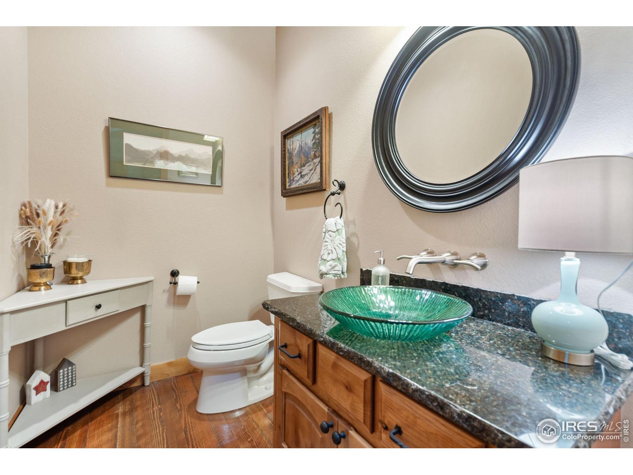 8265 Spinnaker Bay Drive Windsor, CO 80528 - Photo 20 of 40 a bathroom with a toilet a sink and a mirror