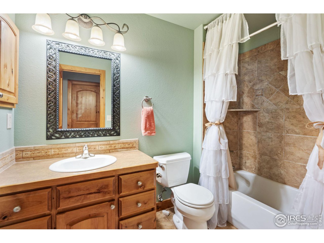 8265 Spinnaker Bay Drive Windsor, CO 80528 - Photo 21 of 40 a bathroom with a sink a toilet and shower