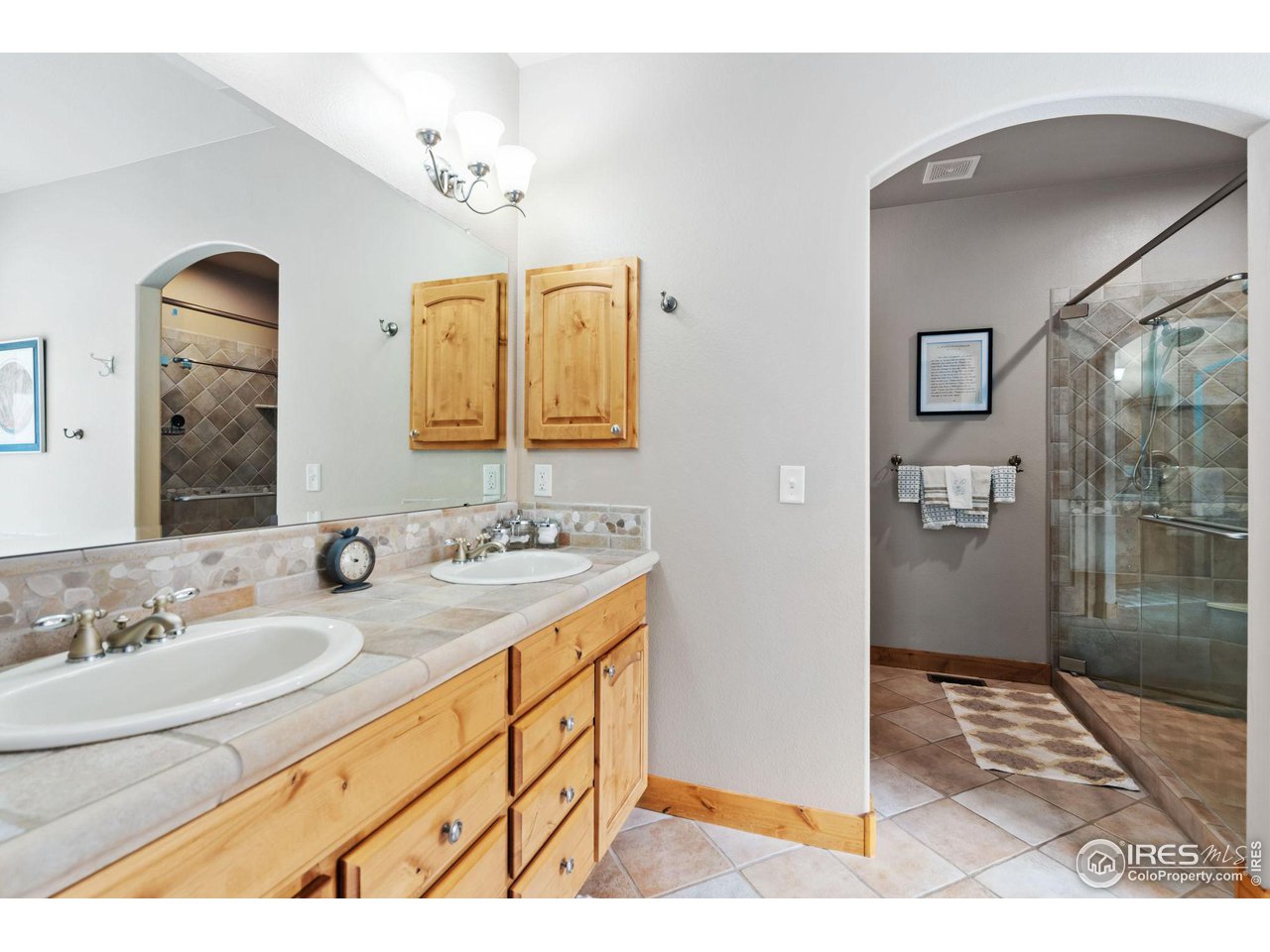 8265 Spinnaker Bay Drive Windsor, CO 80528 - Photo 23 of 40 a bathroom with a sink and a mirror