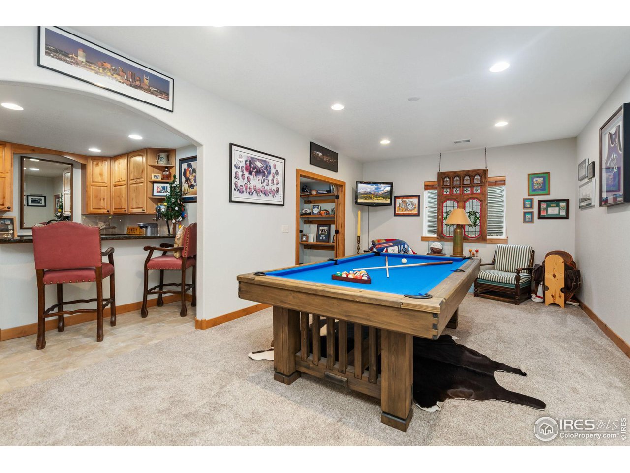 8265 Spinnaker Bay Drive Windsor, CO 80528 - Photo 28 of 40 a living room with furniture pool table and a table
