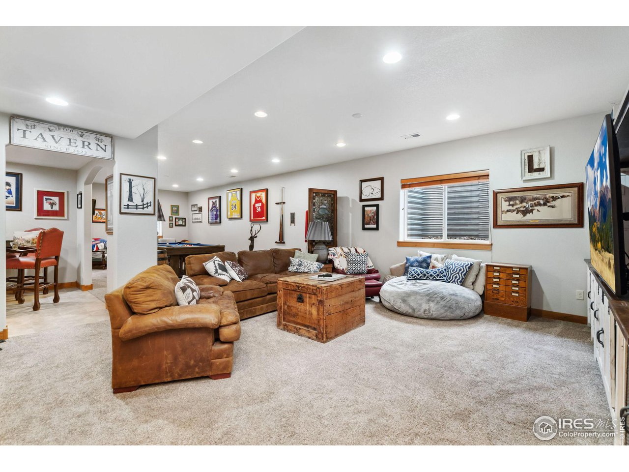 8265 Spinnaker Bay Drive Windsor, CO 80528 - Photo 32 of 40 a living room with furniture and a large window