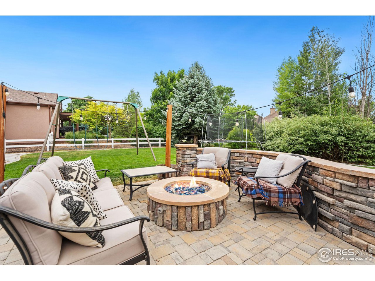 8265 Spinnaker Bay Drive Windsor, CO 80528 - Photo 38 of 40 a view of a patio with a table chairs and a table