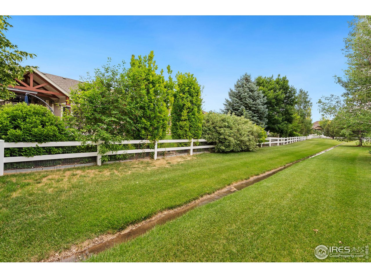 8265 Spinnaker Bay Drive Windsor, CO 80528 - Photo 40 of 40 a view of a golf course with a lake