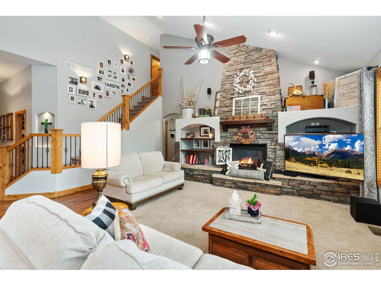 8265 Spinnaker Bay Drive Windsor, CO 80528 - Photo 5 of 40 a living room with fireplace furniture and a flat screen tv