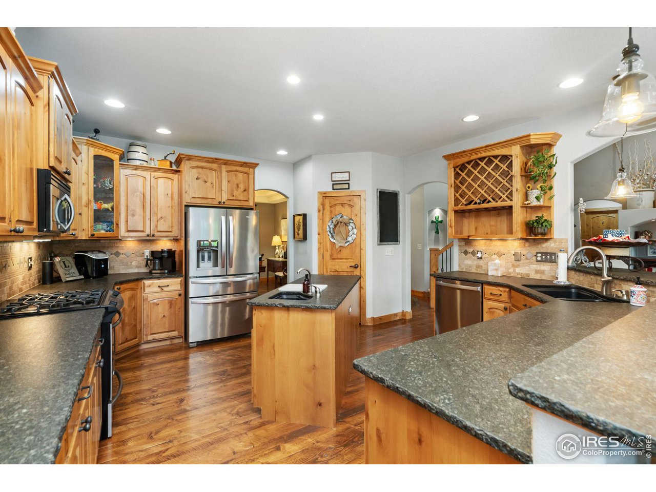 8265 Spinnaker Bay Drive Windsor, CO 80528 - Photo 10 of 40 a kitchen with stainless steel appliances granite countertop a refrigerator a stove and a sink