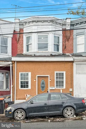 a front view of a house with parking space
