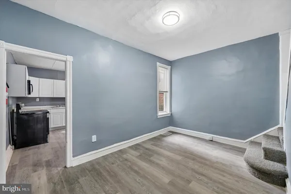 a view of livingroom with hardwood floor and a sink
