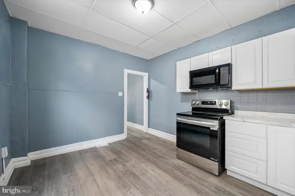 a kitchen with granite countertop a stove top oven and sink
