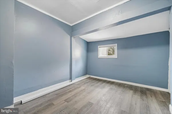 a view of a big room with wooden floor and windows