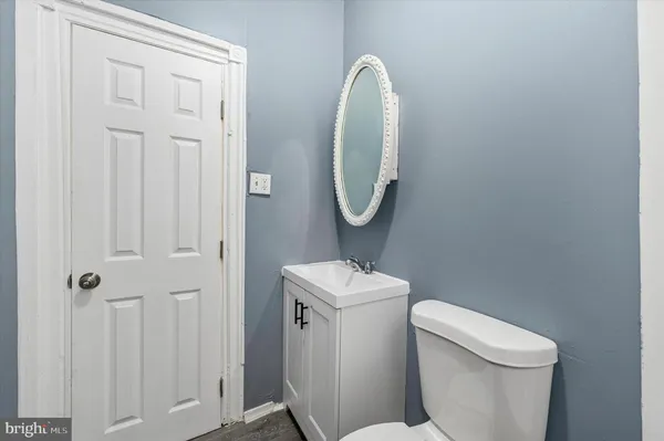 a white toilet sitting next to a bathroom sink