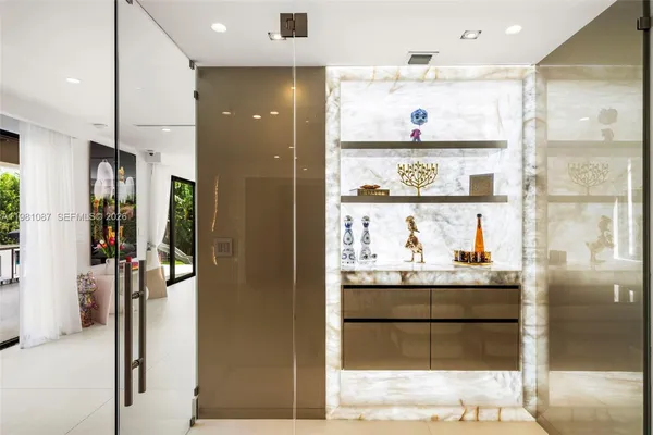 a kitchen with stainless steel appliances kitchen island granite countertop a refrigerator and cabinets