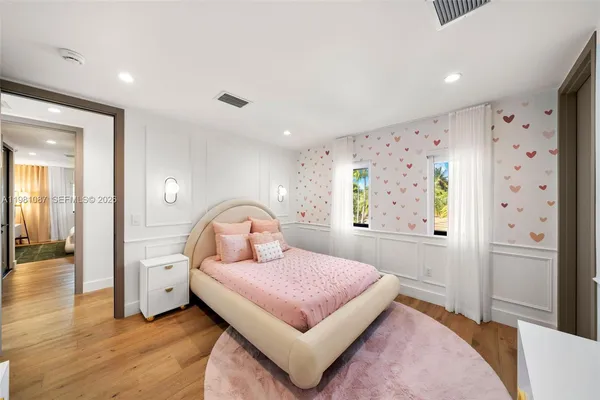 a bedroom with a large bed and a window