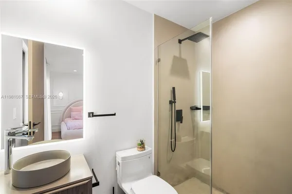 a bathroom with a toilet and a shower