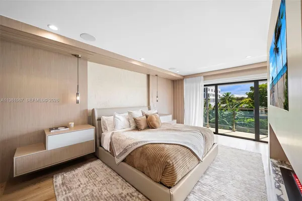 a bedroom with a bed couch and a large window