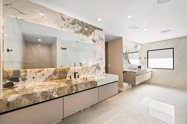 a large white kitchen with a large window