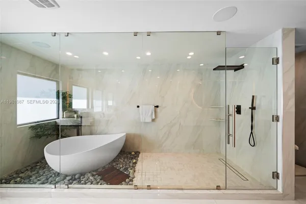 a bathroom with a granite countertop sink mirror and shower