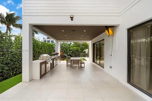 a view of a patio with a table and chairs and potted plants
