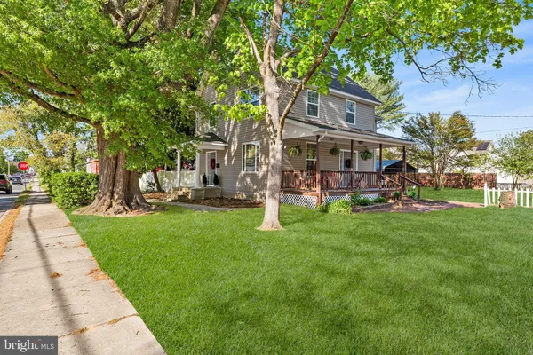 a view of a house with a yard porch and sitting area