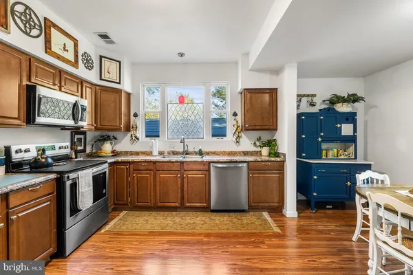 a kitchen with a table chairs refrigerator and cabinets