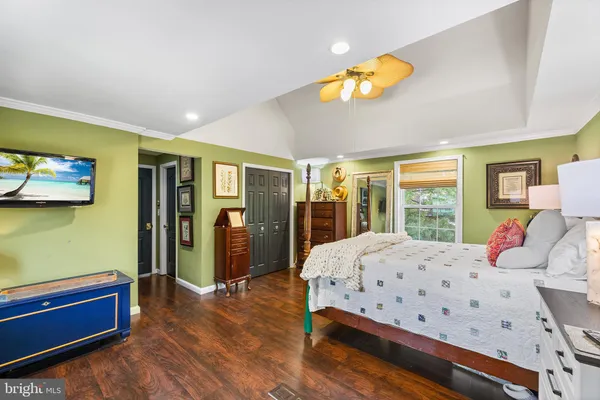 a bedroom with a large bed and a chandelier