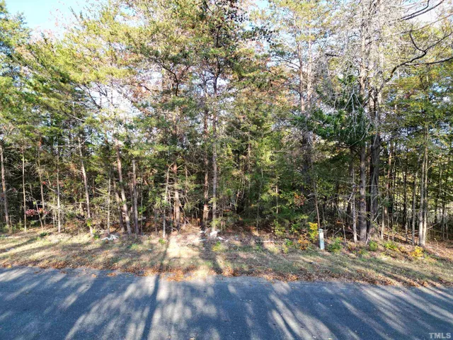 a view of a yard with wooden fence