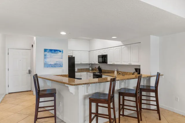 a kitchen with stainless steel appliances kitchen island granite countertop a sink and cabinets