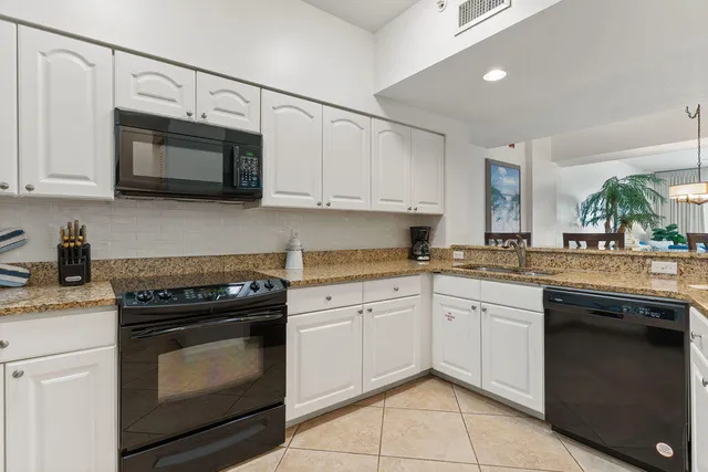 a kitchen with cabinets stainless steel appliances and a sink
