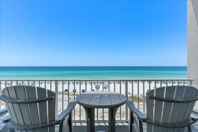 a view of a chairs and table on the deck