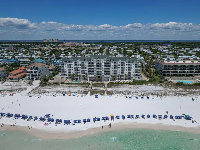 a front view of a building with windows and yard