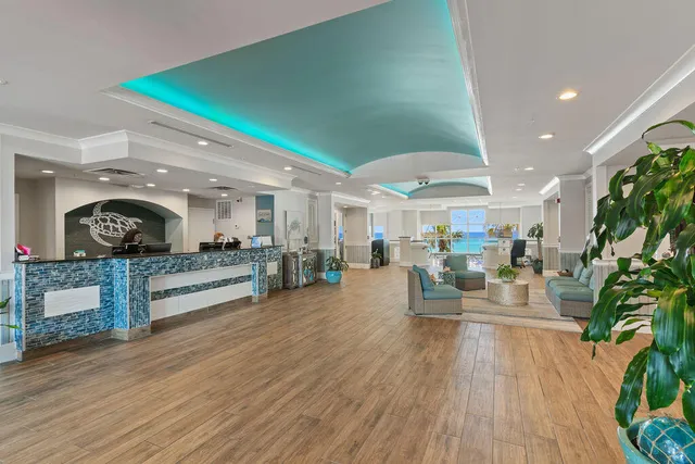 a dining hall with stainless steel appliances kitchen island granite countertop a dining table and chairs