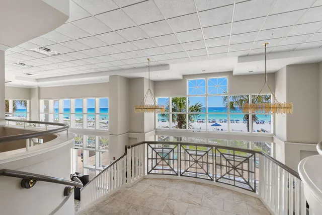 a room with lots of wooden furniture and windows