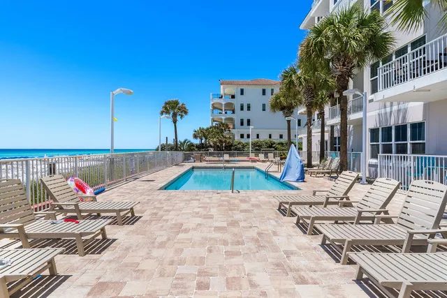 a view of a balcony with wooden floor and outdoor seating