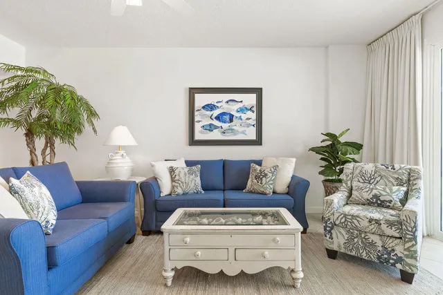 a living room with furniture and a potted plant