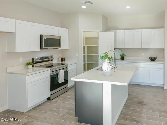 a kitchen with a sink stove and microwave