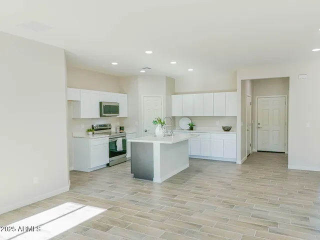 a view of kitchen with microwave a sink and refrigerator