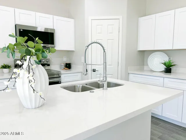 a kitchen with a sink a counter and cabinets