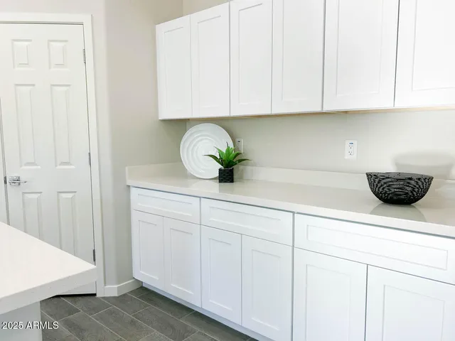 a kitchen with white cabinets and a sink