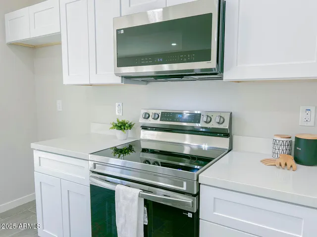 a kitchen with stainless steel appliances granite countertop a sink and a microwave