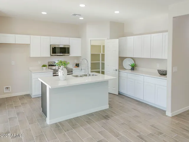 a bathroom with a sink vanity and mirror