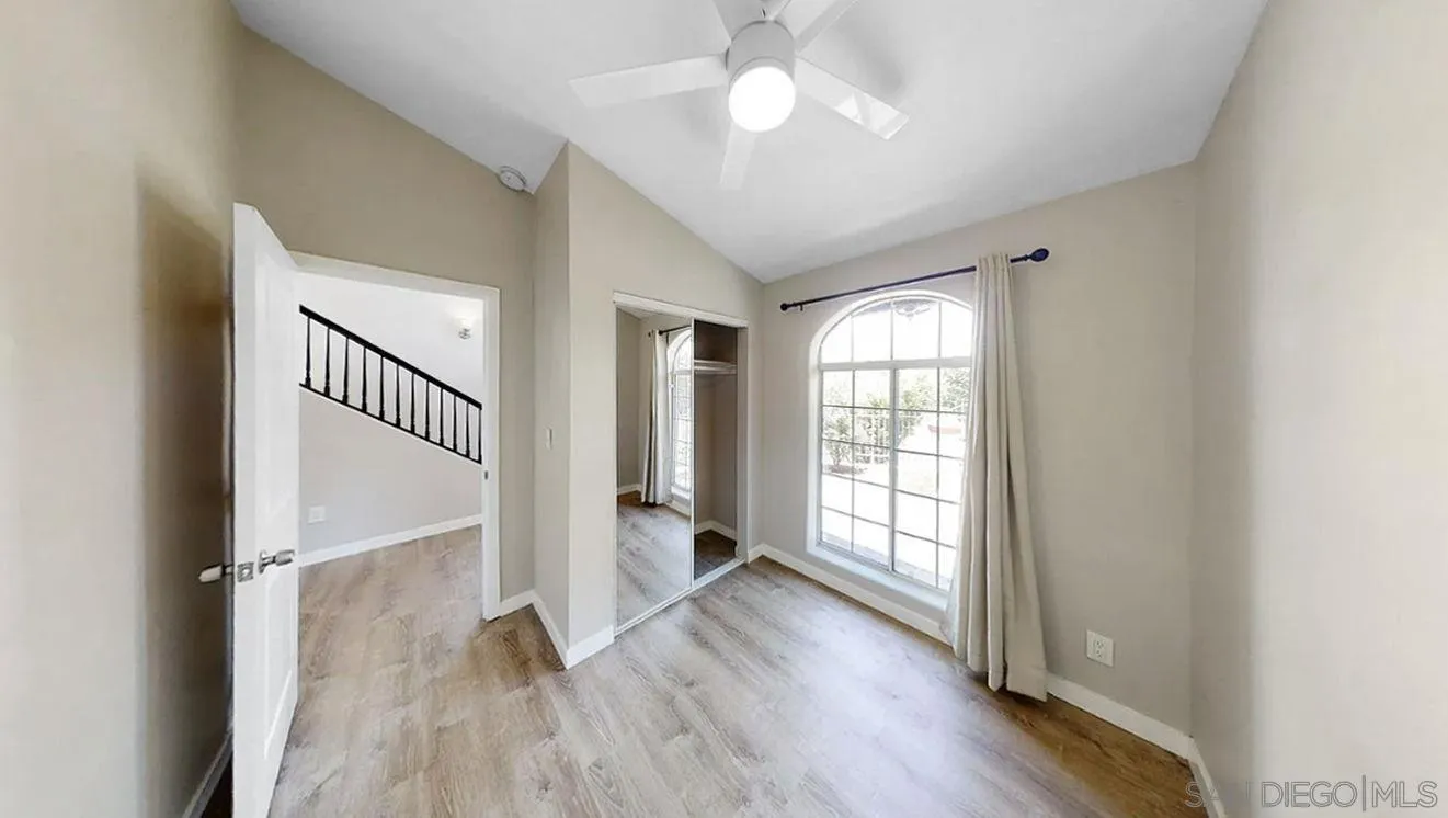 6497-99 Montezuma Road San Diego, CA 92115 - Photo 15 of 23 wooden floor in an empty room with a window