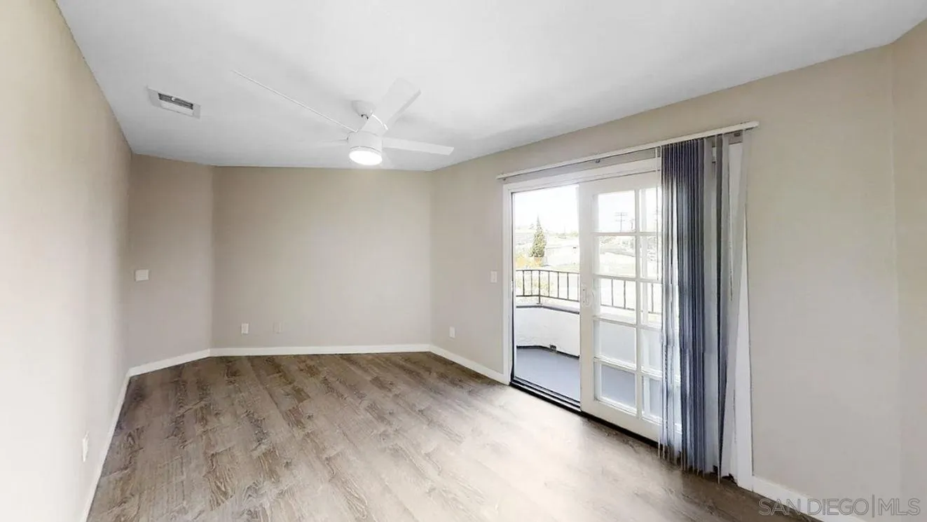 6497-99 Montezuma Road San Diego, CA 92115 - Photo 6 of 23 wooden floor in an empty room with a window