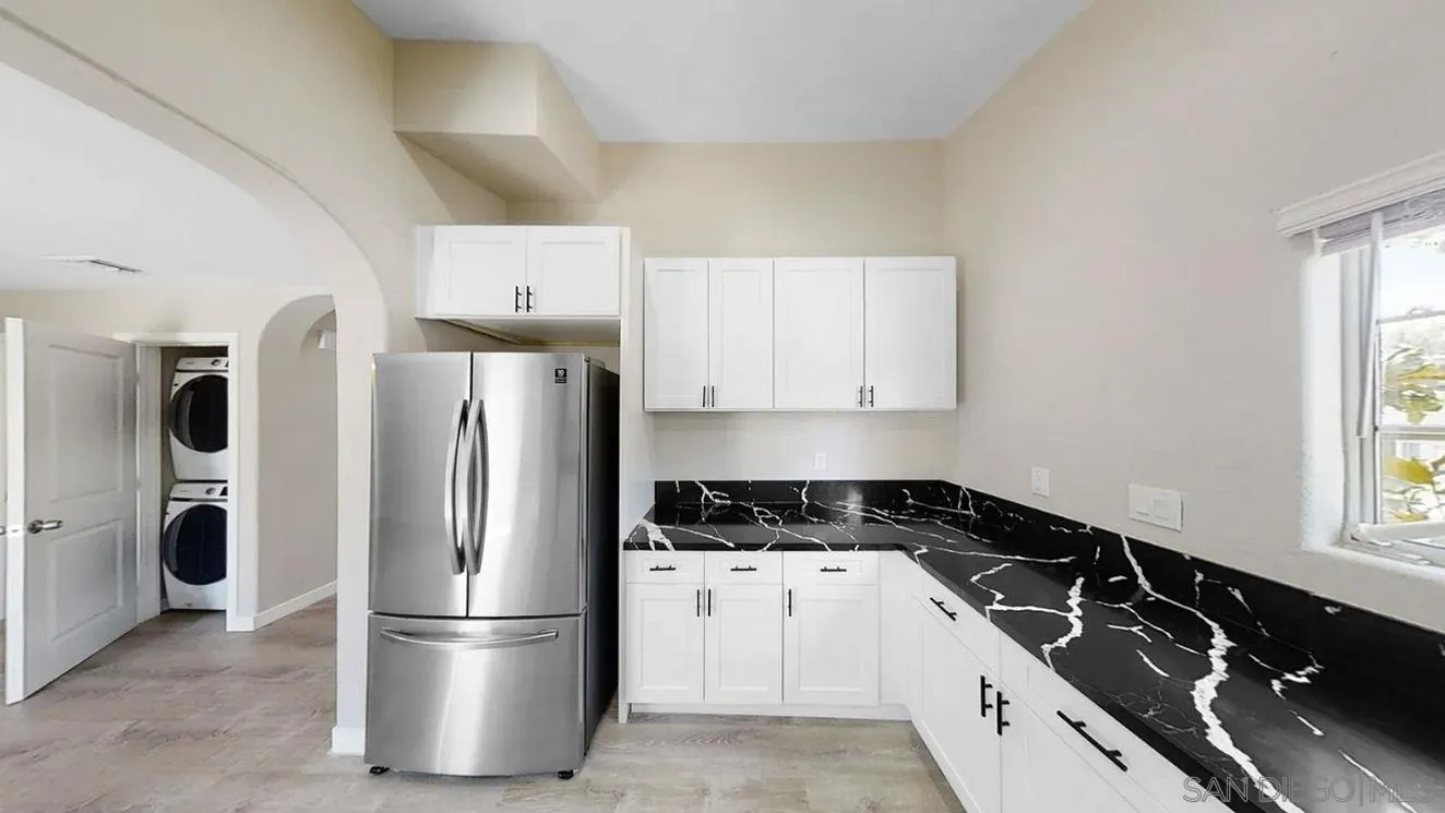 6497-99 Montezuma Road San Diego, CA 92115 - Photo 7 of 23 a kitchen with a refrigerator a stove a sink and a window