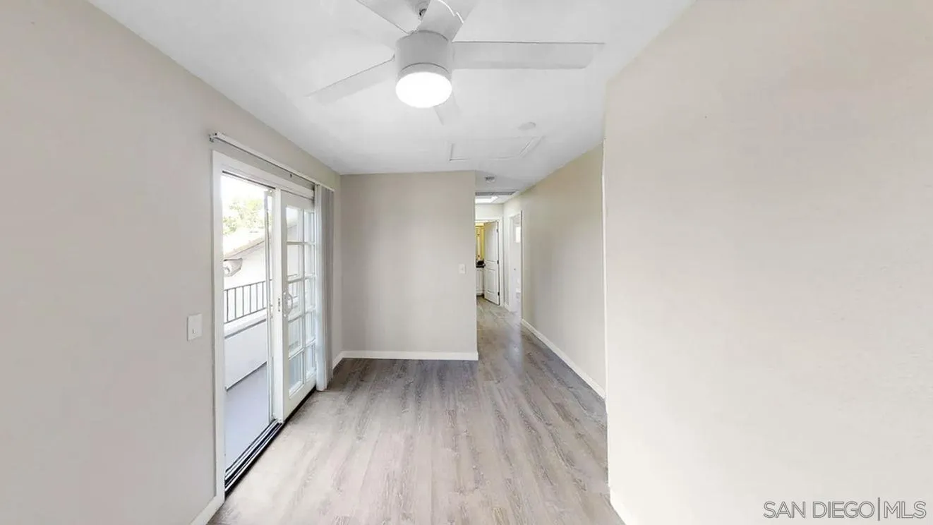 6497-99 Montezuma Road San Diego, CA 92115 - Photo 10 of 23 an empty room with wooden floor fan and windows