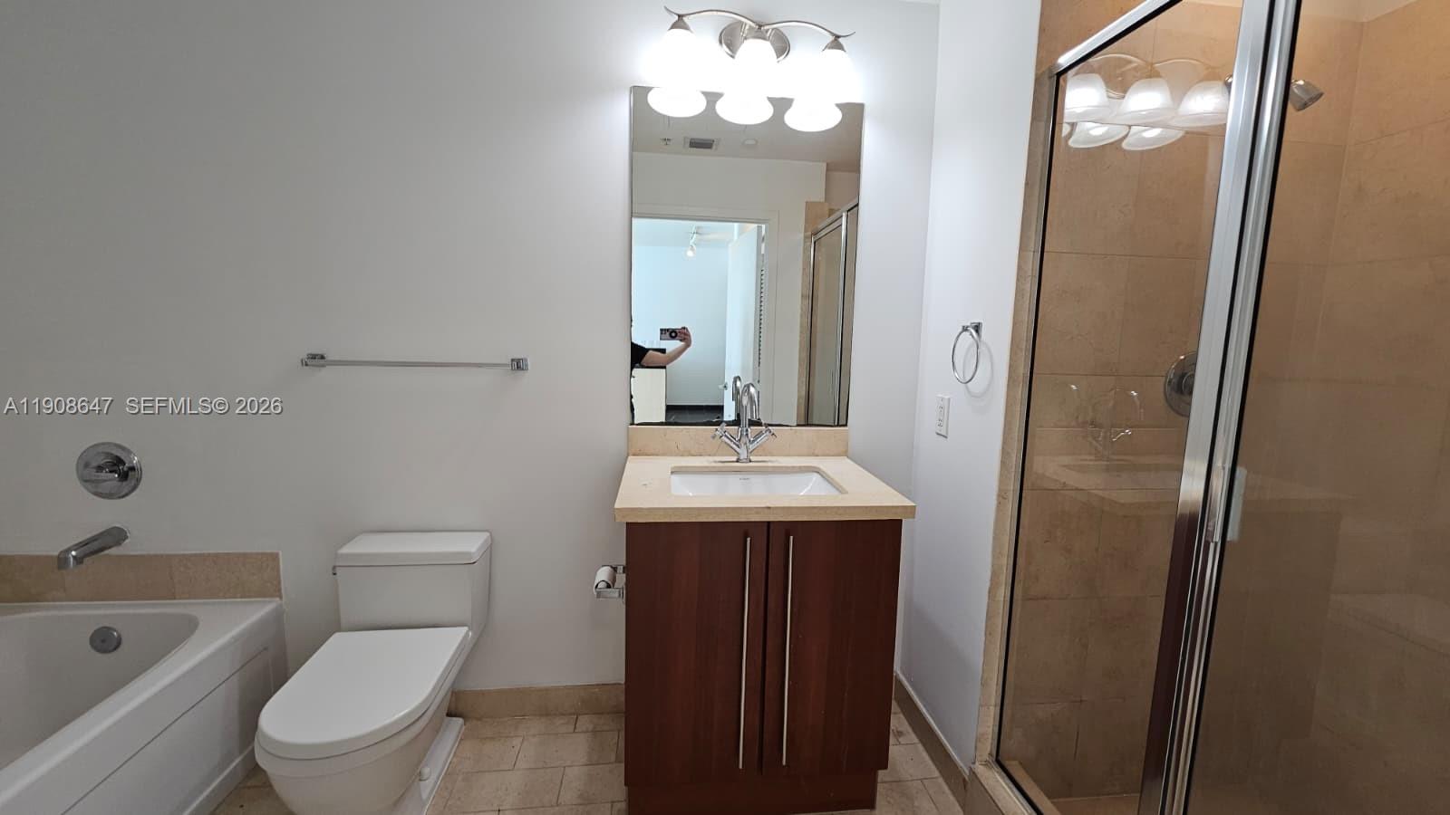 1111 Southwest 1st Avenue, Unit 2124N Miami, FL 33130 - Photo 11 of 34 a bathroom with a sink a toilet and shower