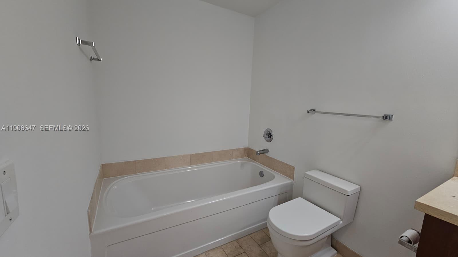 1111 Southwest 1st Avenue, Unit 2124N Miami, FL 33130 - Photo 12 of 34 a white bath tub sitting next to a white toilet