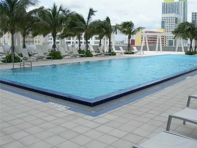 a view of a house with a potted plant and a large tree