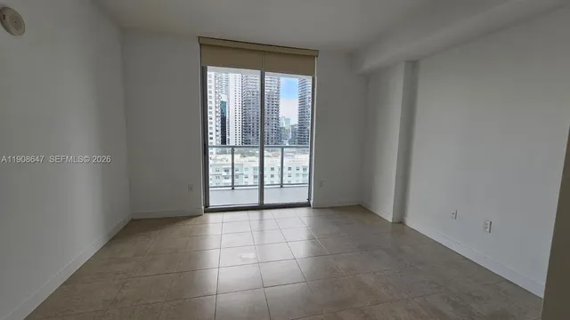 a view of an empty room with a window